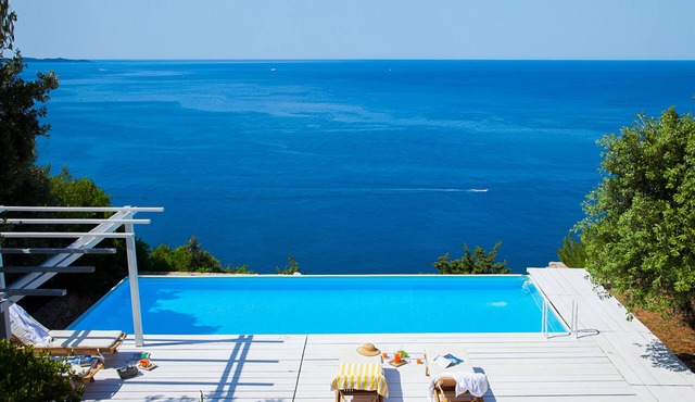Secluded villa with a sea view, a pool, and private beach access